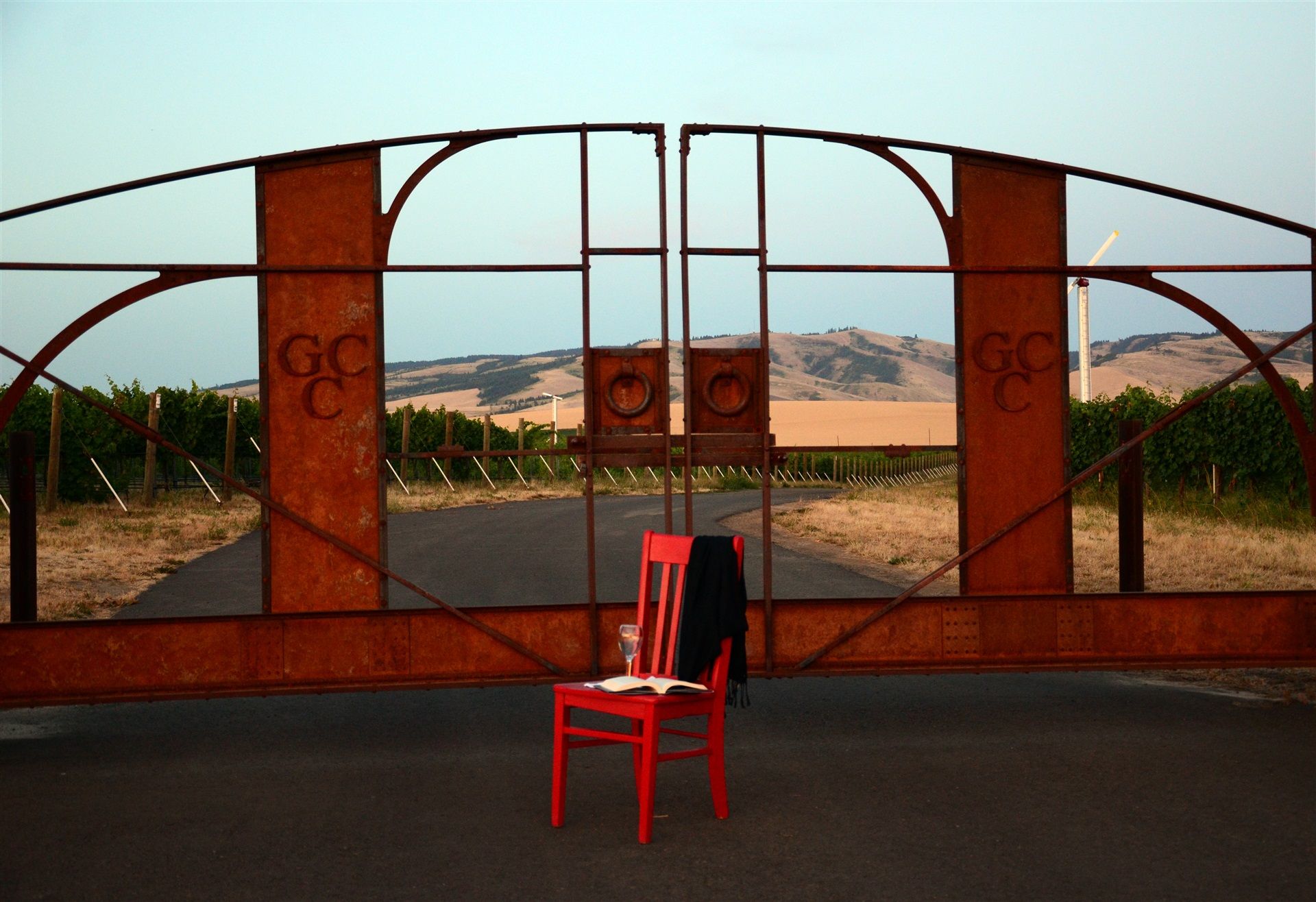 Red chair in front of the entry gate to Garrison Creek Winery